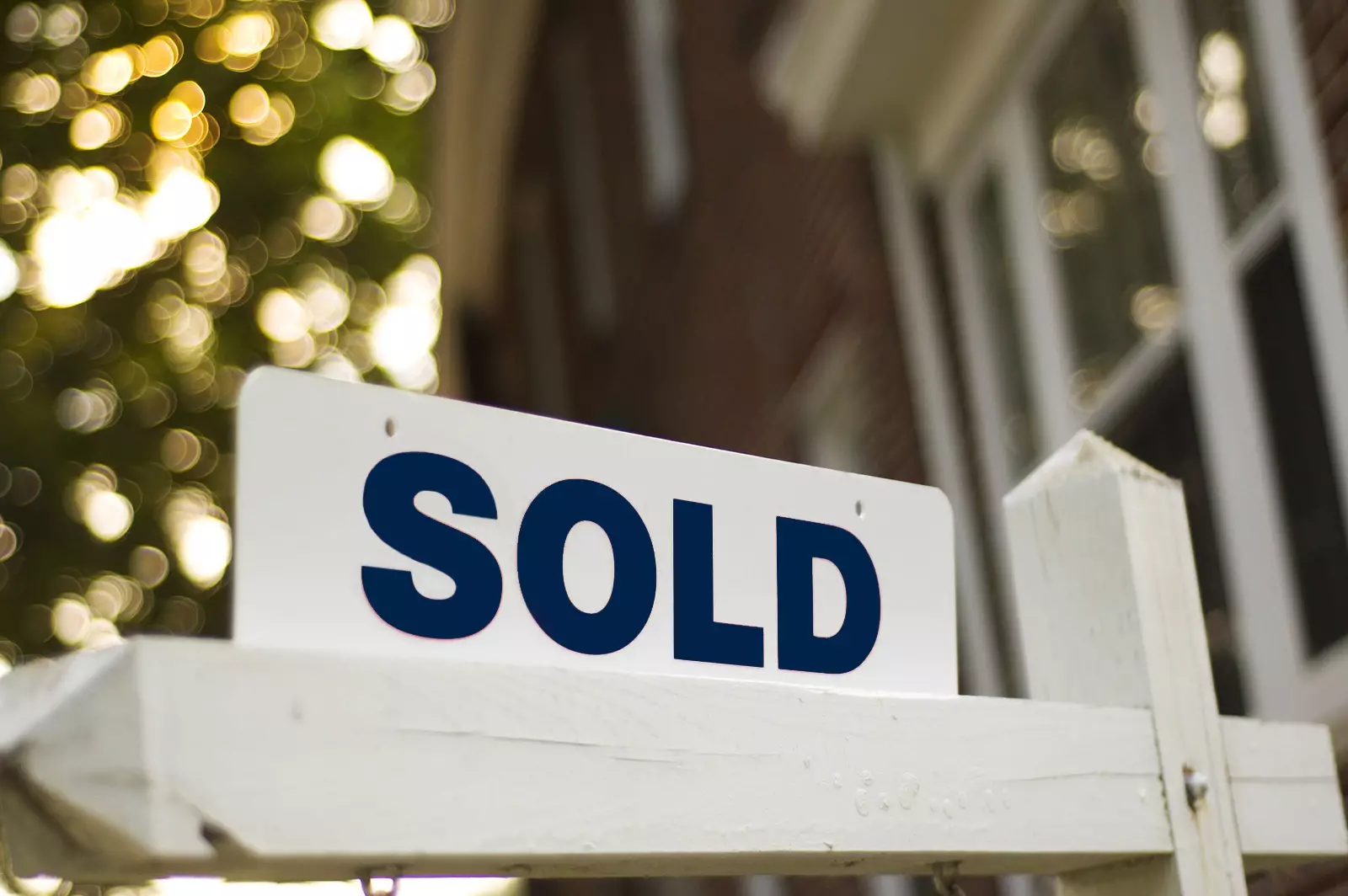 A sold sign in front of a home